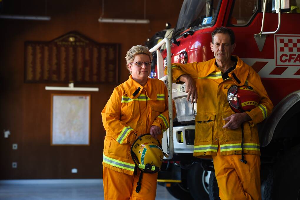 REFLECTING: Tracy McVea and Bruce Forrest of the Beechworth urban and rural fire brigades, with a tanker that was used in the Black Saturday fires. They say it's important residents be fire ready. Picture: MARK JESSER