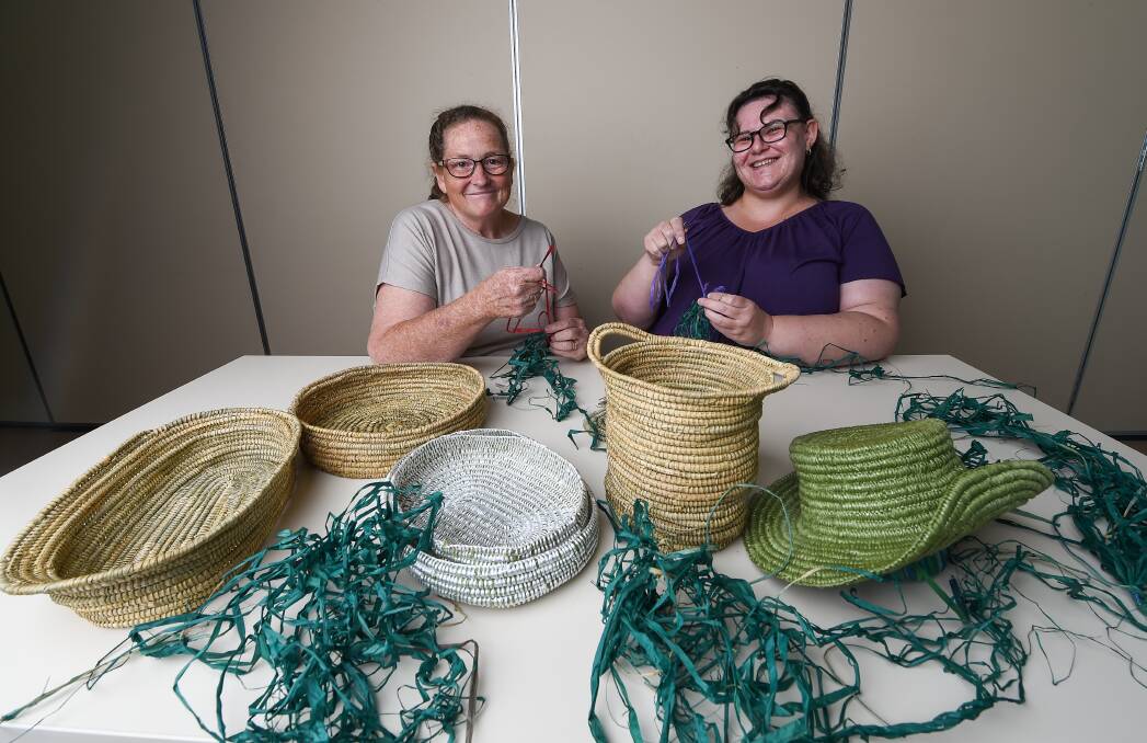 CREATIVE: Jacqueline Tansey teaches Julie McDougall basket weaving at the Birallee Neighbourhood House. A workshop on wicker beds as part of the sustainable living festival is taking place today. Picture: MARK JESSER