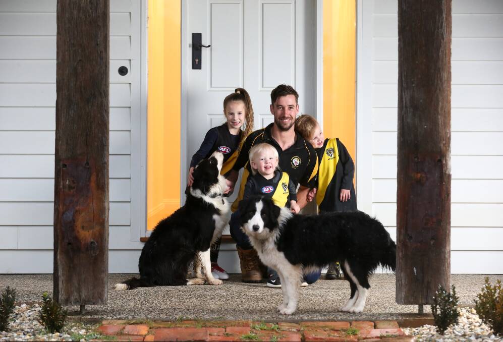 FAMILY FIRST: Barnawartha 200-gamer Josh Spence with his kids Charlie, 5, Jack, 2 and JJay, 3, and dogs Rex and Freddy. Picture: KYLIE ESLER
