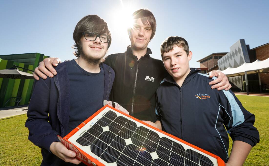 SHINE ON: Aspect School students Matty Parker, 16, and Noah Tobin, 13, with Brad Jones Racing's Danny Sims, at the launch of the 2018 Solar Car Challenge. Picture: JAMES WILTSHIRE