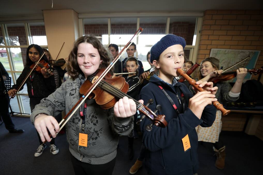 THAT'S ALL FOLKS: Albury's Tania Wallace, 12, and Beechworth's Hugo Davey, 12, help put together a folk performance.