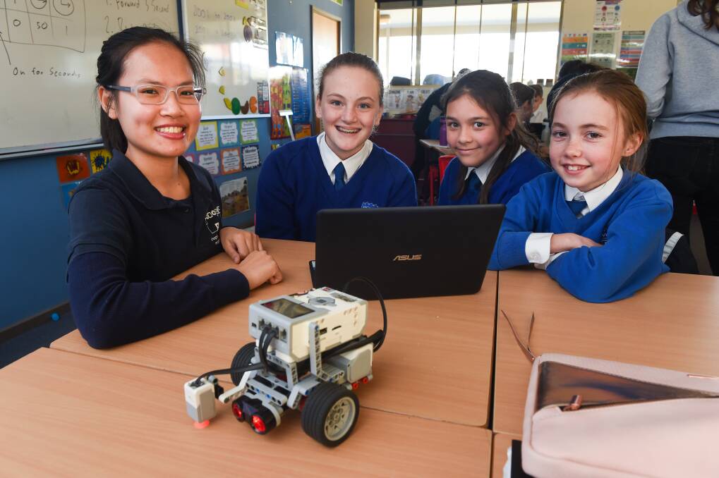 FUTURE ENGINEERS: Maria Ngo from Robogals with year six students Zoe Dudley, 11, Katie Brunow 11 and Inez Cathie, 11. Picture: MARK JESSER