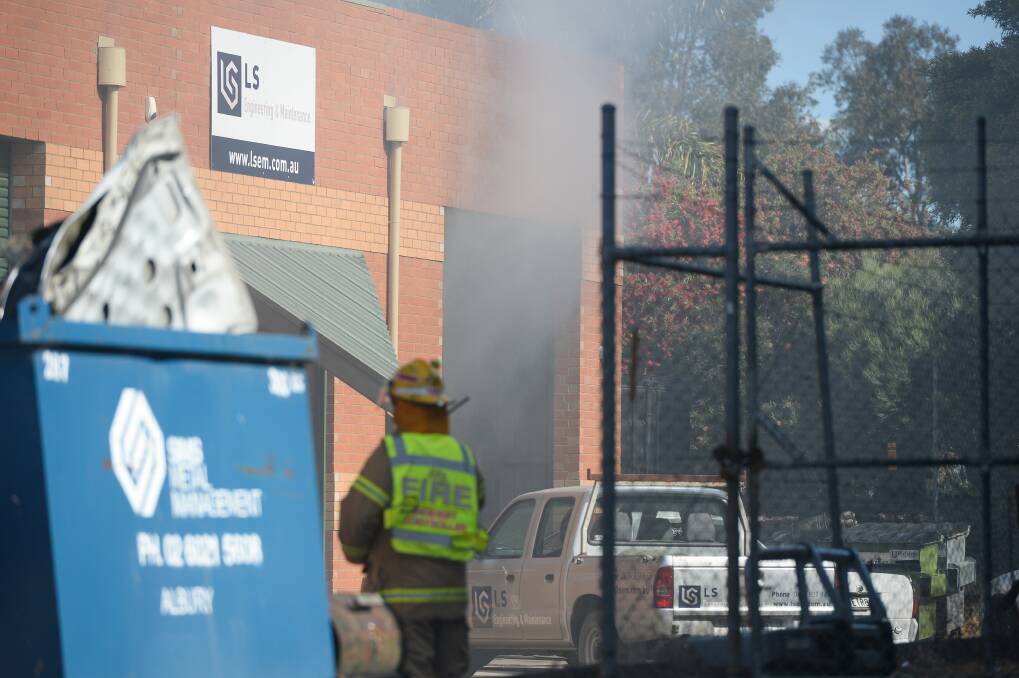 A Trafalgar Street workshop, where firefighters attended on Saturday afternoon, escaped damage after a vehicle two men had been working on caught fire. Picture: MARK JESSER