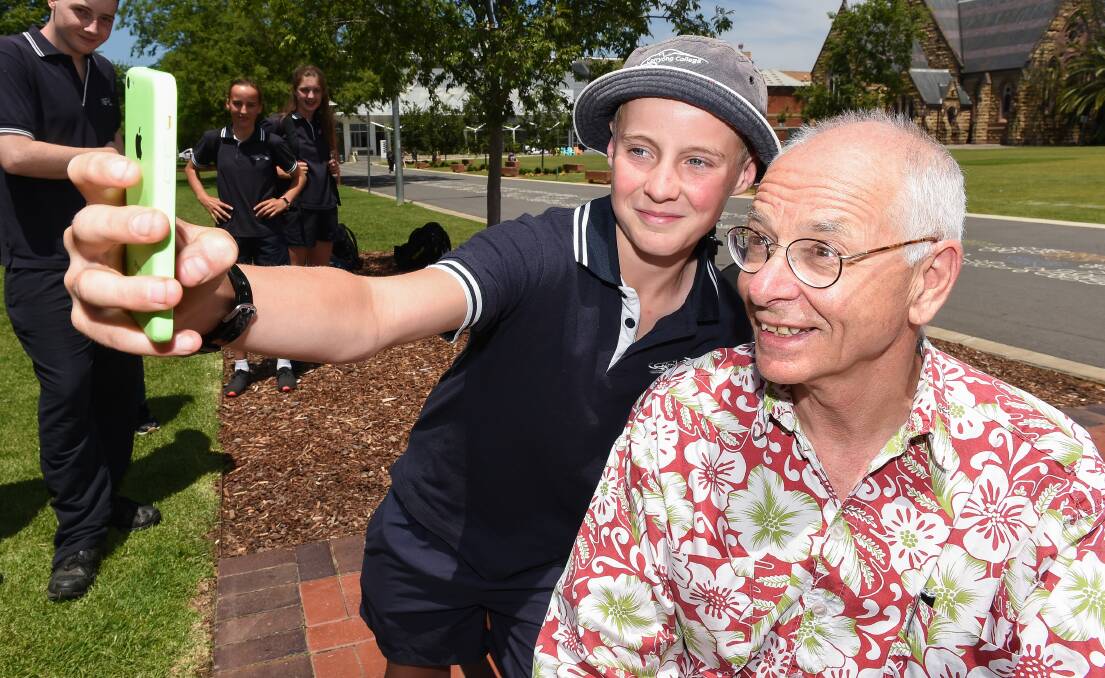 STUNNING SCIENCE: Corryong High School student Lachy Martin, 13, takes a selfie with Dr Karl Kruszelnicki on Monday. Picture: MARK JESSER