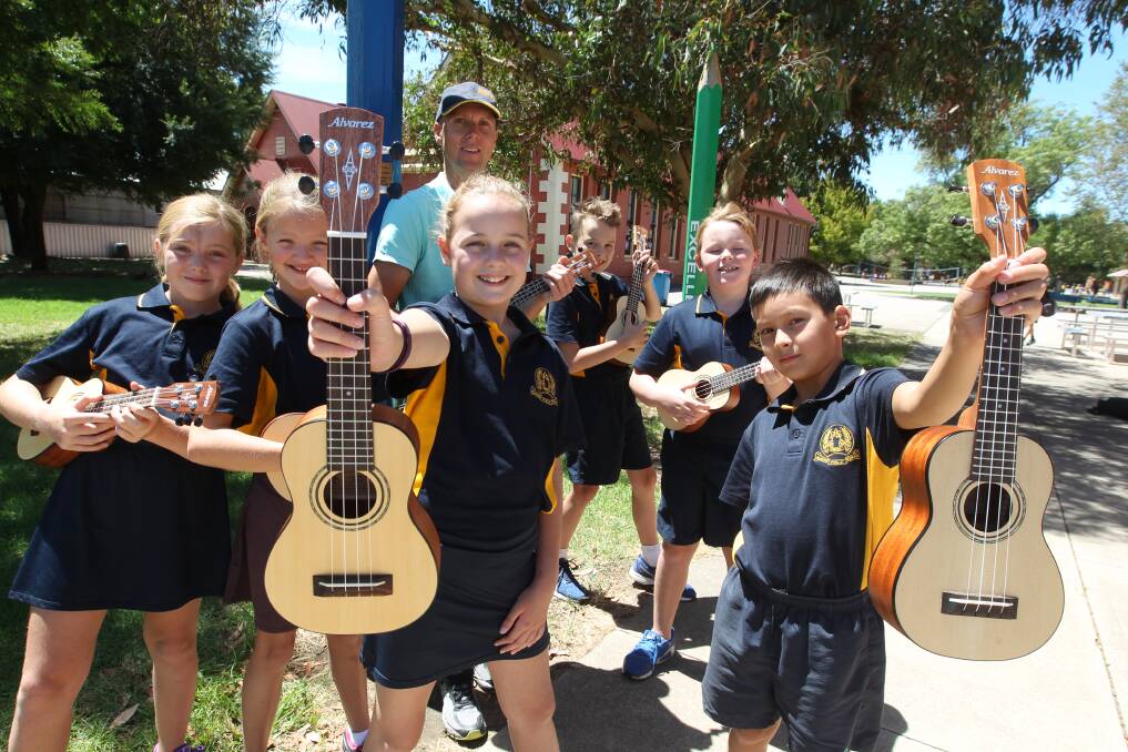 STRUMMERS: Albury Public School students and teachers are loving the switch from recorders to ukuleles in music class. Picture: CHRIS YOUNG