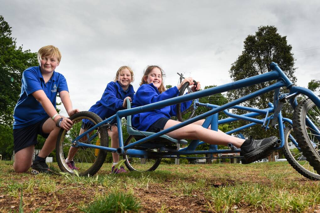 DAREDEVILS: Luke McAuliffe, 11, Mary Nolan, 10 and Tara Nolan, 12, are ready for this weekend's billy cart races. Picture: MARK JESSER