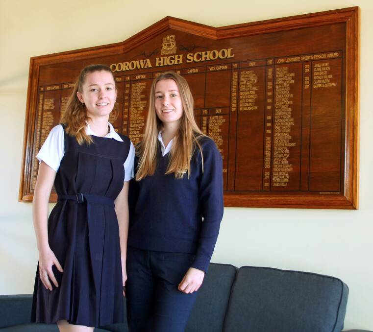 FLASHBACK: Corowa high School student Olivia Hughes models the 1968 box-pleat tunic uniform, next to her twin sister Sarah in the modern uniform. Picture: SUPPLIED 