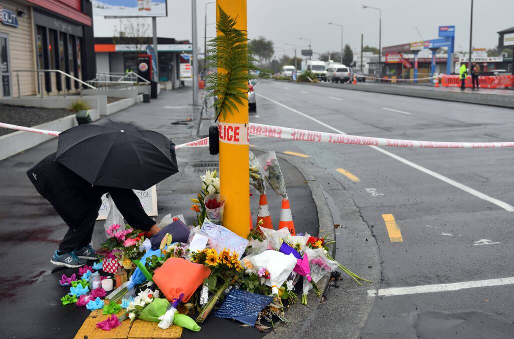 GRIEVING: A member of the public places flowers at Linwood, one of the Christchurch mosques involved in the massacre. Picture: AAP