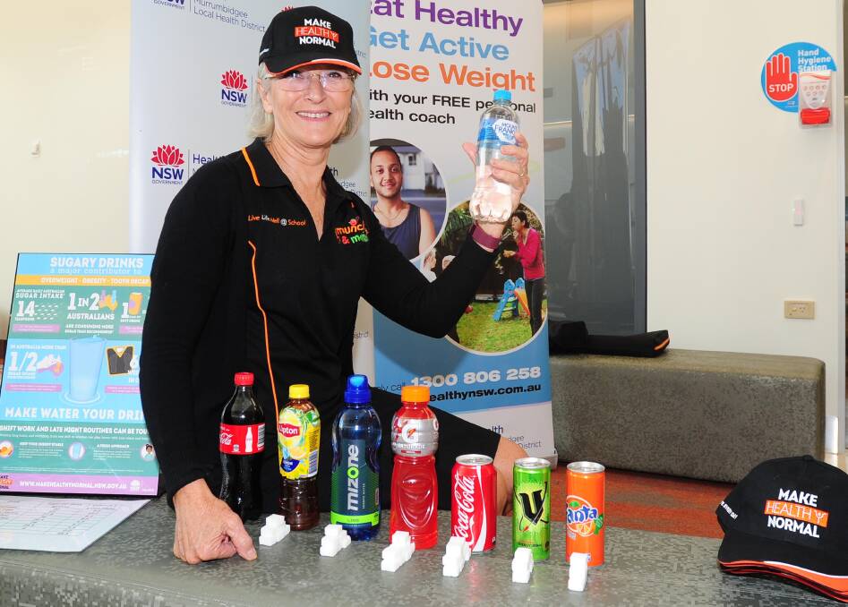 WISE CHOICE: Health promotion manager Christine May shows how much sugar is in common drinks, which are now banned from sale in MLHD facilities. Picture: Kieren L Tilly.