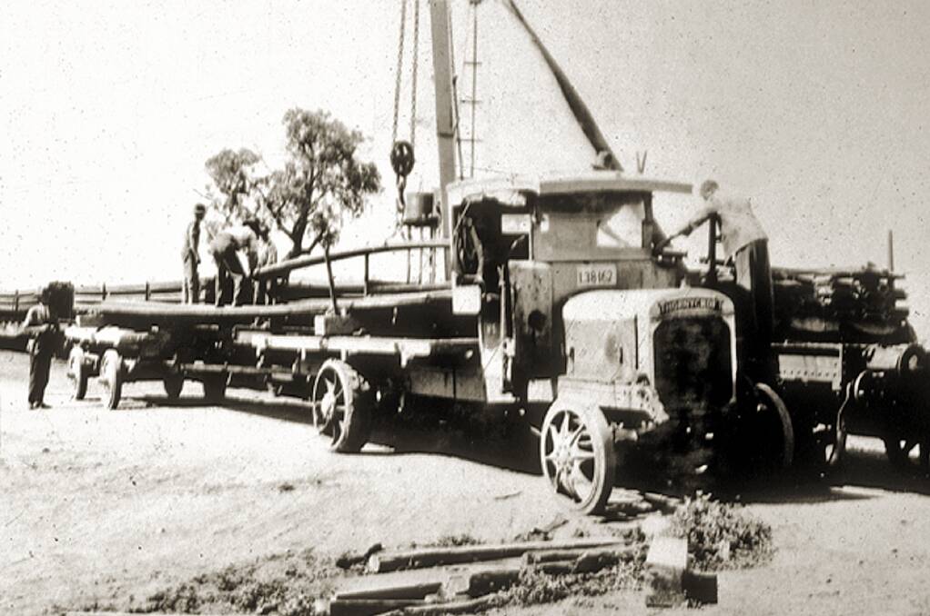 AT WORK: One of the 10 Thornycroft lorries being loaded by workers. The lorries ferried equipment from the Albury railway siding to the NSW construction site.