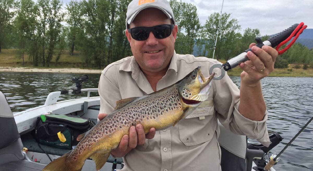 TOP TROUT: Jason Smith caught this brown trout trolling at Khancoban pondage between Christmas and New Year. The catch included four brown trout and two redfin.