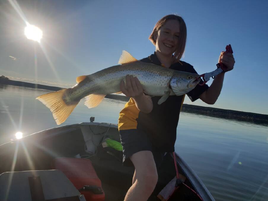 SENSATIONAL: A very happy Olive Wiseman, 10, holds up her first trout, a 66 centimetre brown that she caught while trolling at Lake Hume recently. 