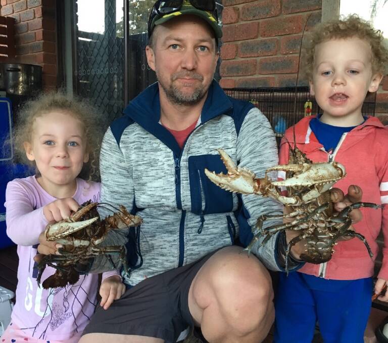 CRAY TIME: Justin Knobel, with Grace (left) and Eli (right), has had a good run, catching these crays outside Rutherglen. He says Grace demolished two of them. 