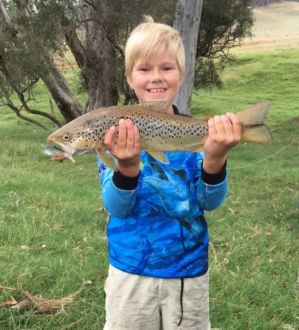 STUDENT: After hitting the fishing books, young Ricky Rast's been at it again, catching this 4lb brown trout up at Mitta. He was using his new bait caster for the first time.