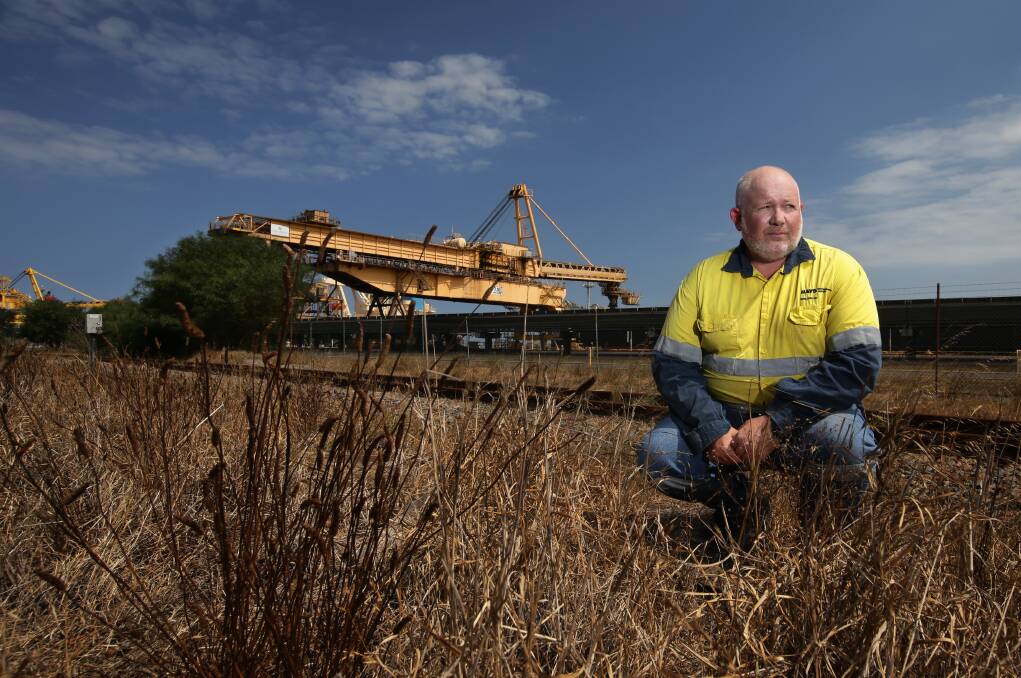 Warning: Environmental scientist and former coal industry worker Jamie Miller near coal export infrastructure at Kooragang. Mr Miller believes Australia has "dropped the ball" in responding to climate change. Picture: Simone De Peak. 