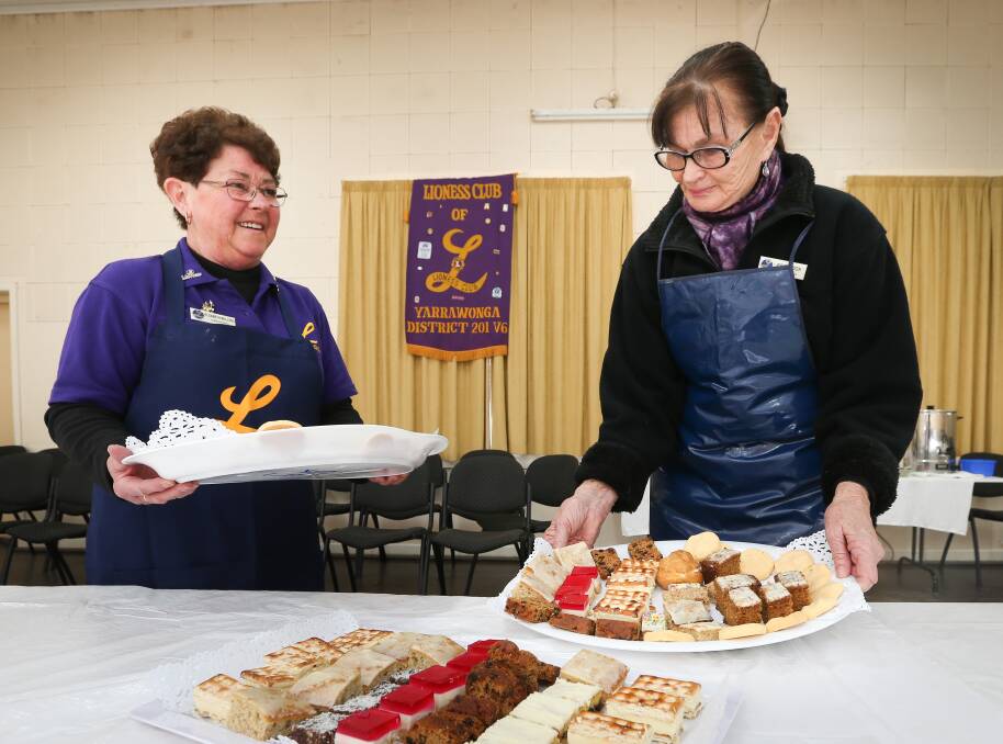 TASTY TREATS: Liz Mullens and Faye Cook helped out in the community hall at the gala ball and dance weekend.