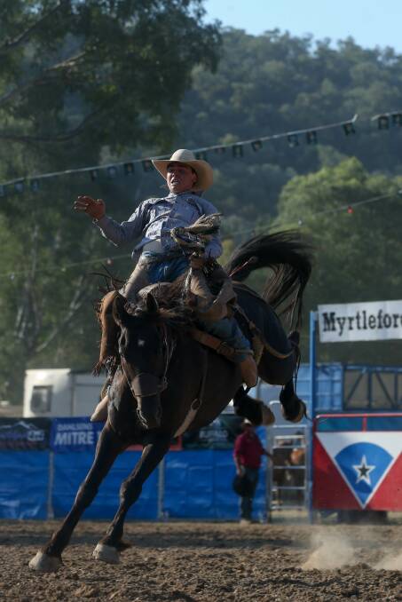 HANG ON: Sam Weston tightens his grip in a bid to stay aboard Bruiser Brown at the Myrtleford Golden Spurs Rodeo. Picture: TARA TREWHELLA