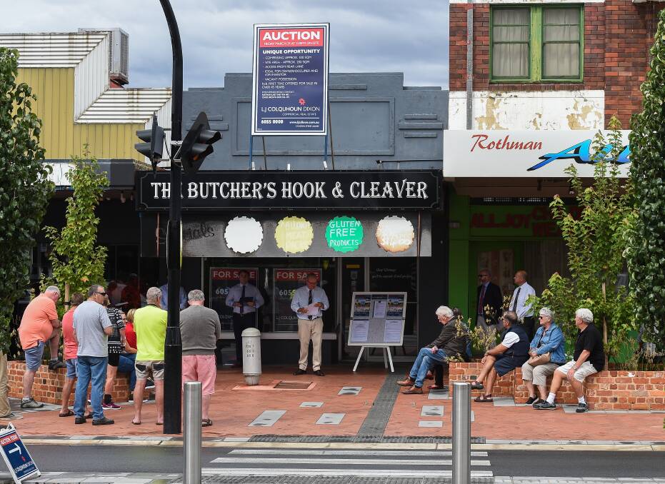 PASSED IN: A small crowd of interested onlookers was on hand to witness a long-standing Wodonga butcher shop at the northern end of High Street not sell at auction. Picture: MARK JESSER