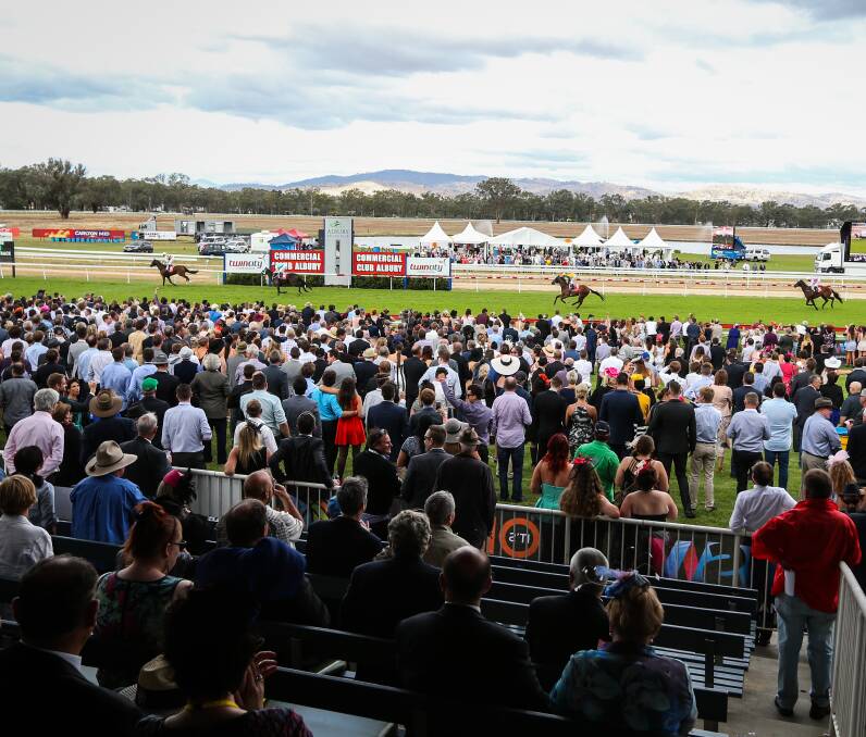 BRAVING THE ELEMENTS: A big crowd of more than 12,000 people still turned out for the Albury Gold Cup despite overcast skies and early rain putting the meeting in doubt. Pictures: JAMES WILTSHIRE