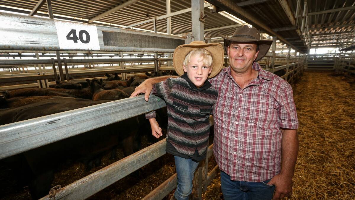 HAPPY DAYS: Myrtleford's Peter Boyd and son Israel, 10, enjoyed a profitable sale at the Wodonga weaner sales. Pictures: JAMES WILTSHIRE
