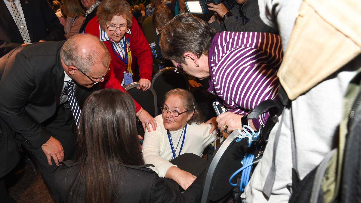 Scott Morrison checks in CWA conference delegate Margaret Baxter after being knocked to the ground in the attempted egging of the PM. Picture: MARK JESSER