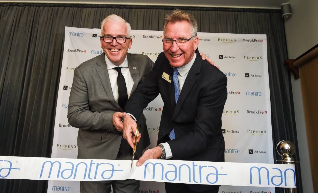 GRAND OPENING: Mantra Group’s executive director of operations Mark Hodge, left, and Albury mayor Kevin Mack cut the ribbon. Pictures: MARK JESSER