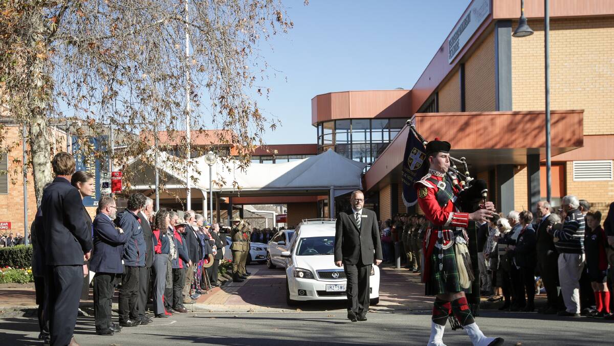 FINAL GOODBYE: Tim Fischer's coffin is transported from the Albury Entertainment Centre following his funeral attended by past and present prime ministers. Pictures: JAMES WILTSHIRE