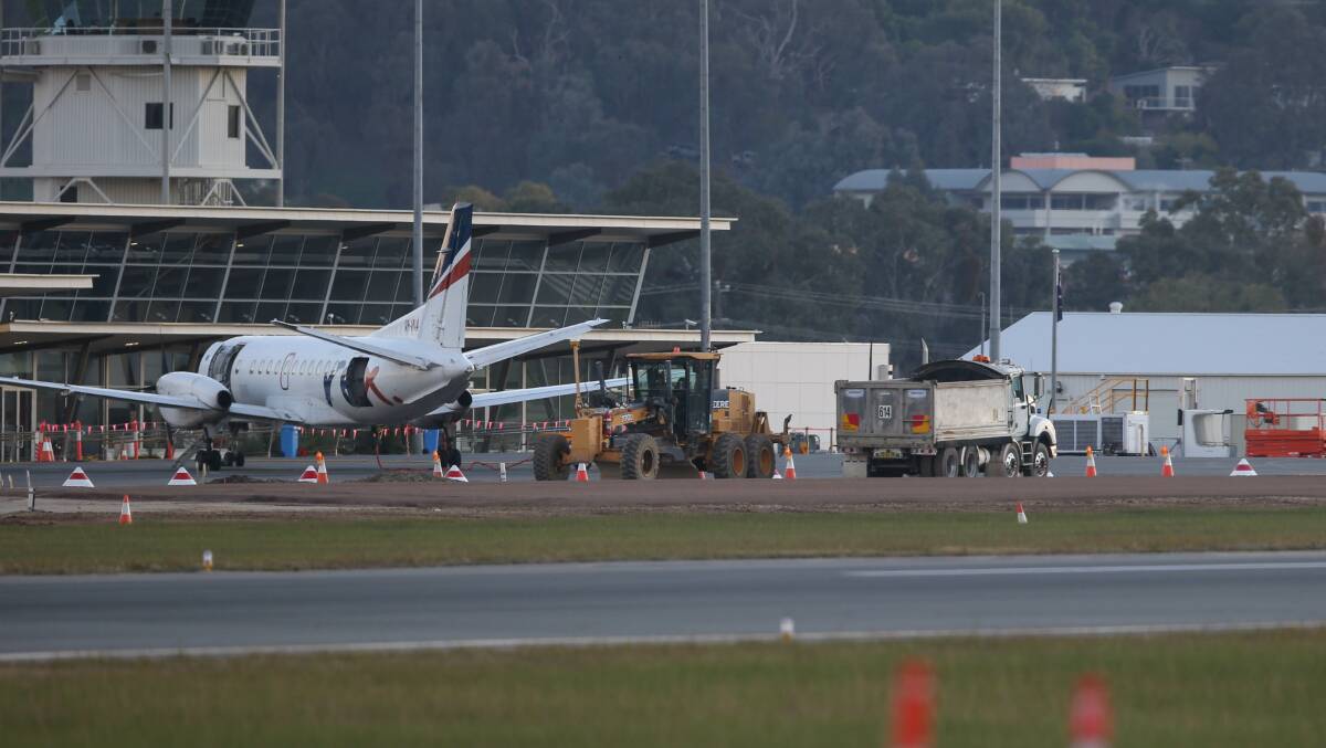CROWDED AREA: Planes and work crews are sharing Albury Airport taxiways during upgrades presently underway. Picture: TARA TREWHELLA