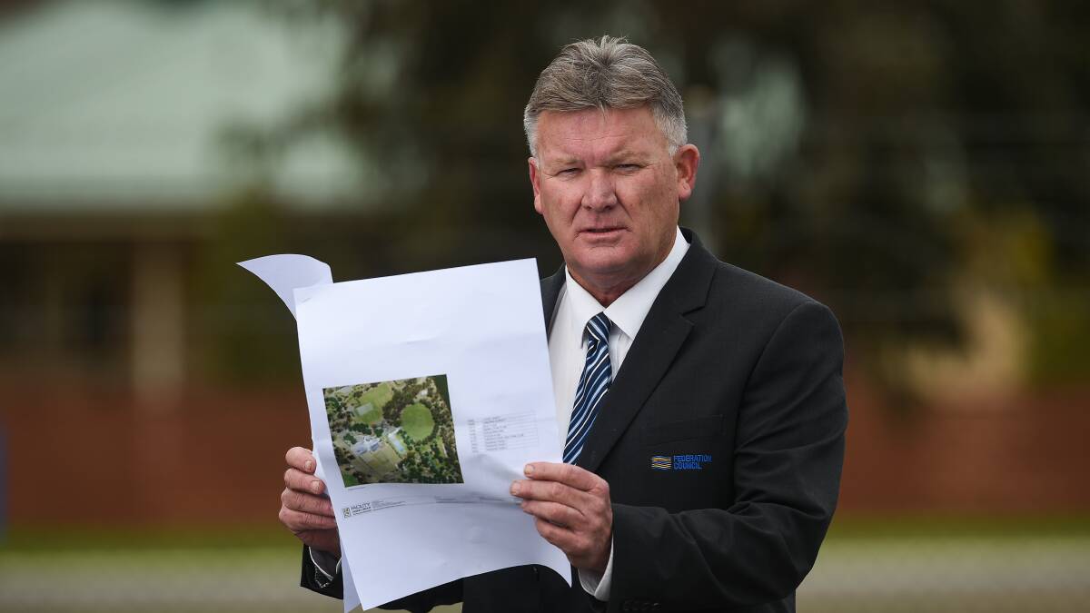 STEP FORWARD: Federation Council mayor Pat Bourke with the final concept design plans for the Corowa pool project. Picture: MARK JESSER