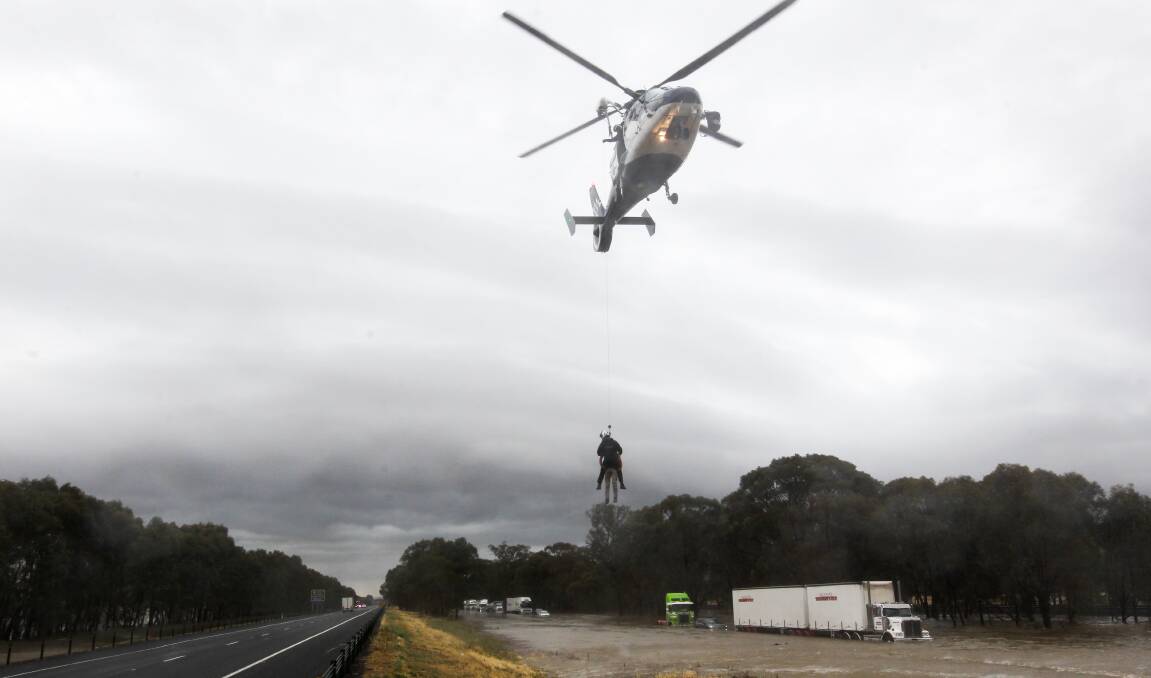 CHOPPER RESCUE: Motorists caught in flash-flooding on the Hume Highway were winched to safety. Picture: BLAIR THOMSON