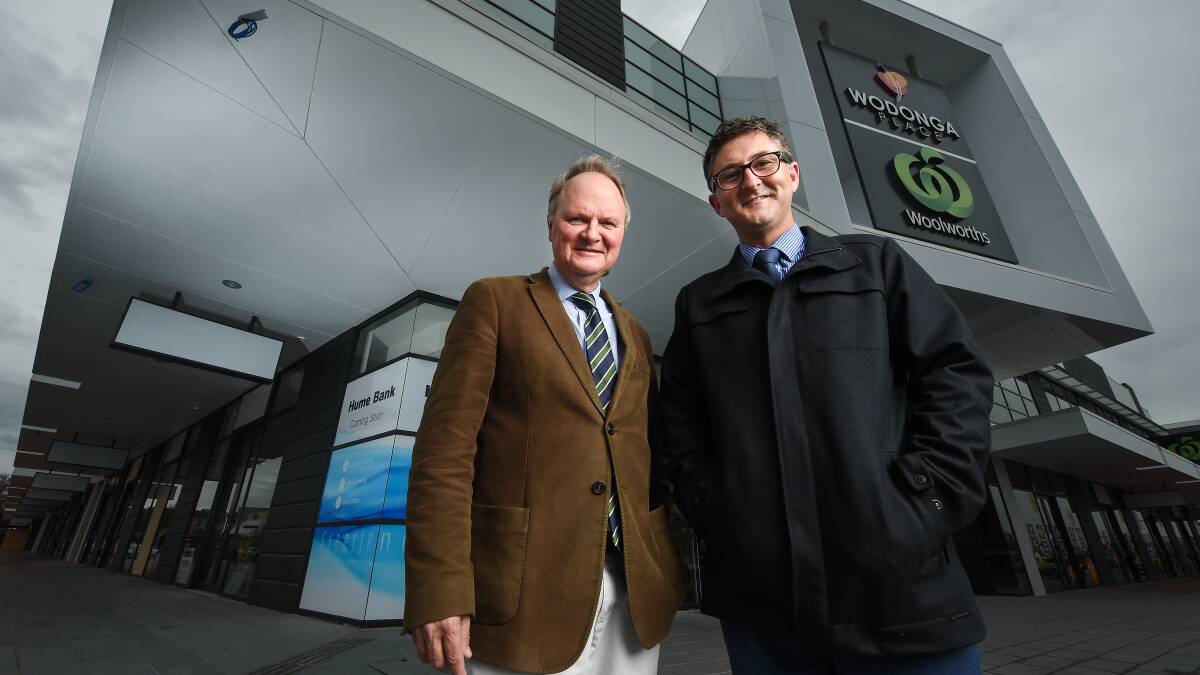 CHANGING PLACES: LJ Colquhoun Dixon agents Andrew Dixon, left, and Corey Finlay  outside the Woolworths redevelopment in central Wodonga. Picture: MARK JESSER