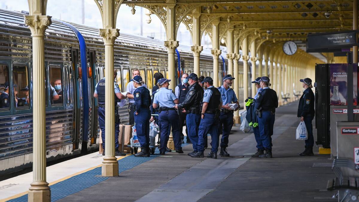 HEADING HOME: NSW Police personnel board an XPT train at Albury Railway Station after working on the border checkpoints. Picture: MARK JESSER