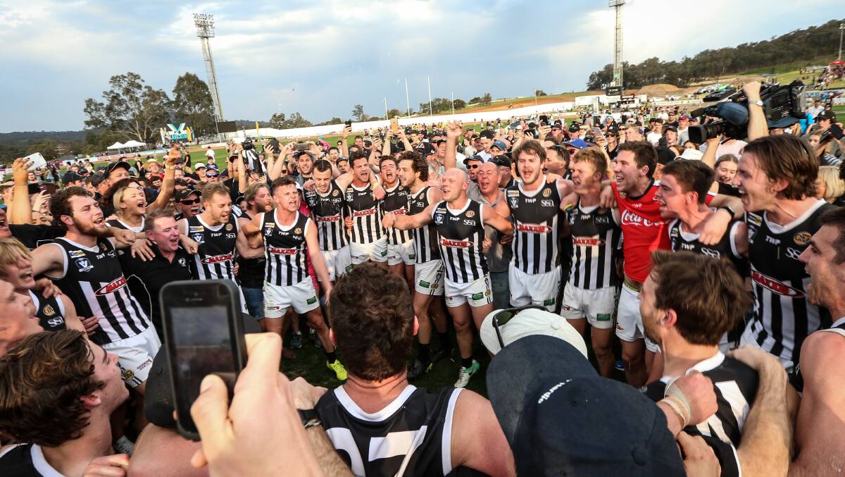 BLACK AND WHITE HEAVEN: Wangaratta players celebrate after beating Albury in the grand final on Saturday. Picture: JAMES WILTSHIRE