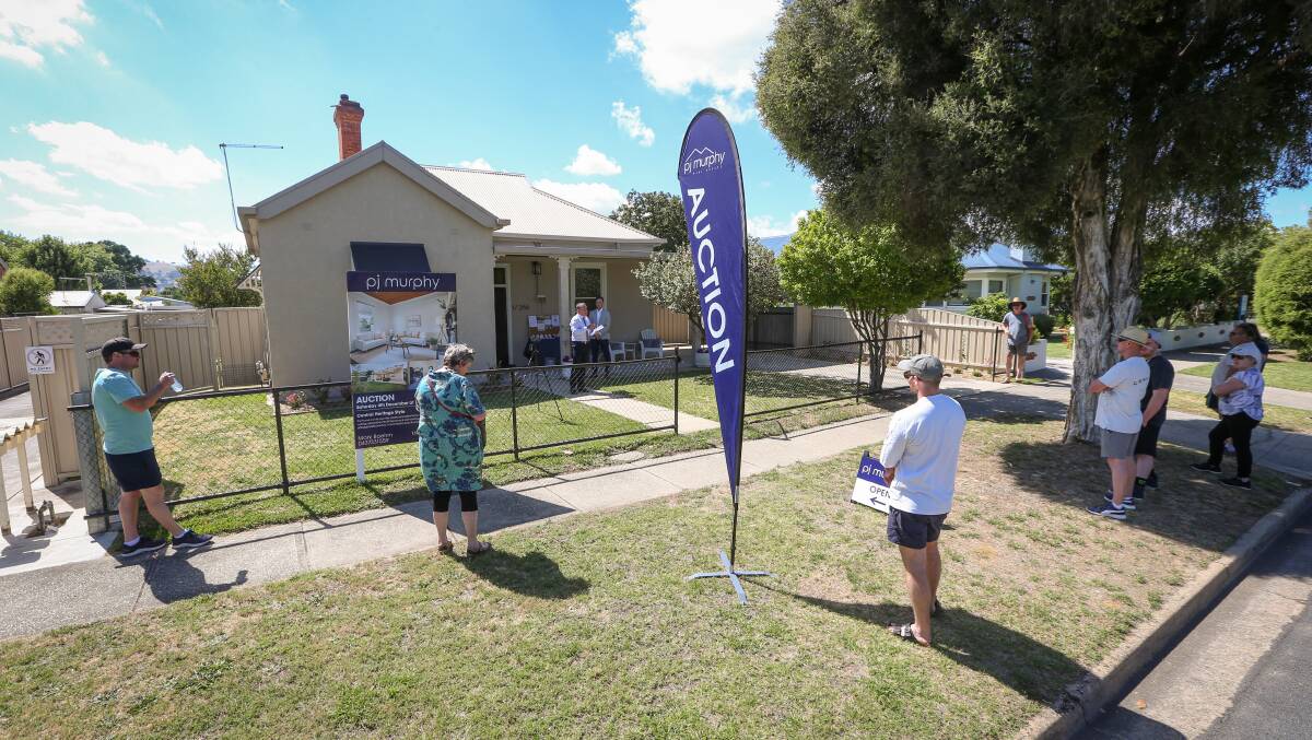 BIDDING DUEL: A small crowd at a Beechworth Road, Wodonga auction on Saturday didn't prevent the property from selling for more than $480,000 under the hammer. Picture: JAMES WILTSHIRE