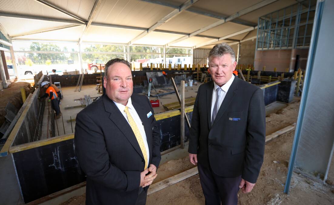 GOING SWIMMINGLY: Federation mayor Pat Bourke, right, and deputy mayor Shaun Whitechurch inspect the Corowa Aquatic Centre project. Picture: JAMES WILTSHIRE