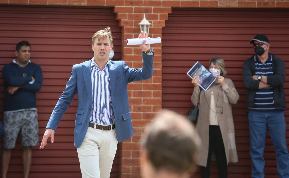 IN DEMAND: Auctioneer Jack Stean was bombarded with bids for the Palm Drive home in East Albury.