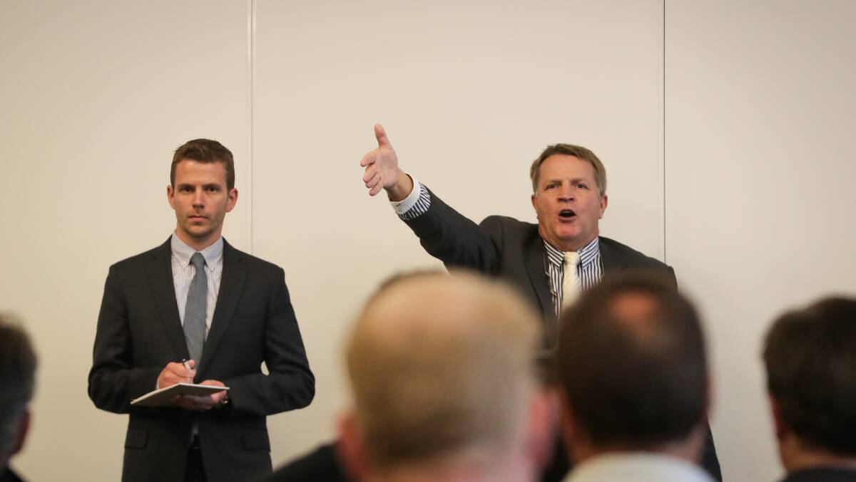 BIDS SOUGHT: Stean Nicholls auctioneer Geoff Steen, right, attempts to raise interest in the T&G Building in Dean Street. Picture: JAMES WILTSHIRE