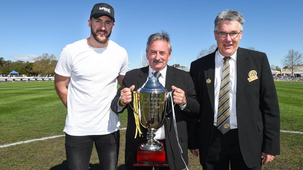 HOLY GRAIL: Injured Collingwood defender Lynden Dunn, SS&A Club chairman Eddie Dunlop and O and M chairman David Sinclair before the big game. Picture: MARK JESSER