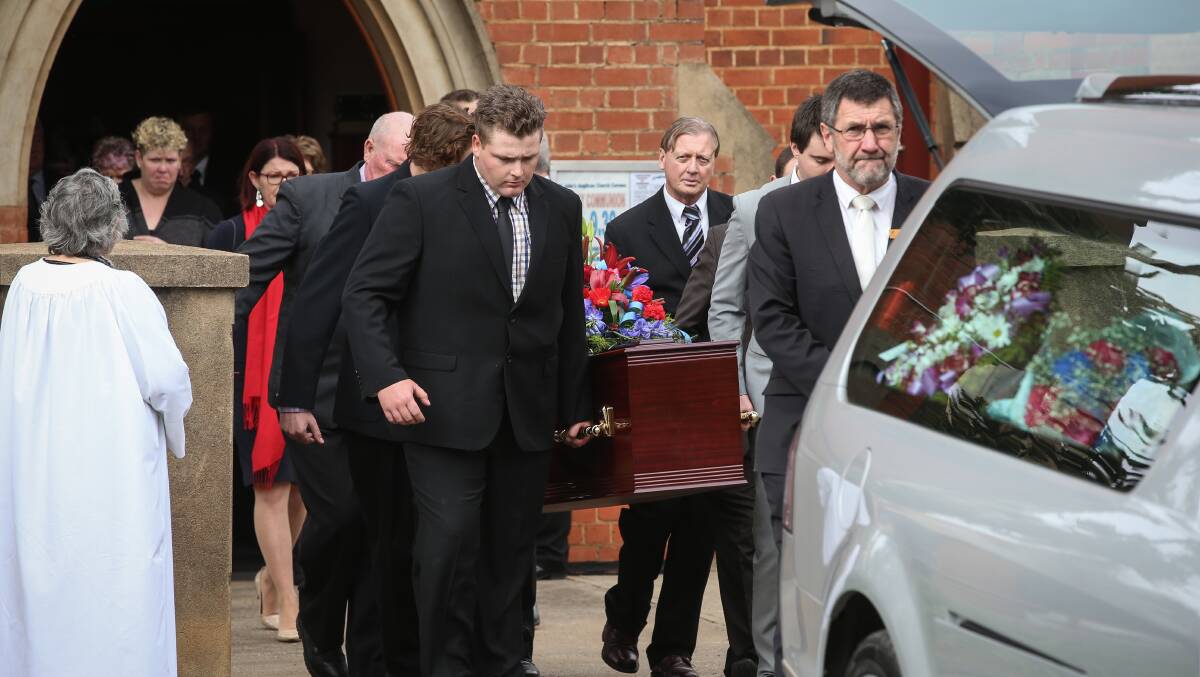 FINAL RACE: Richard Freyer's coffin is lifted into the back of the hearse by pall bearers at his funeral on Saturday. Pictures: JAMES WILTSHIRE