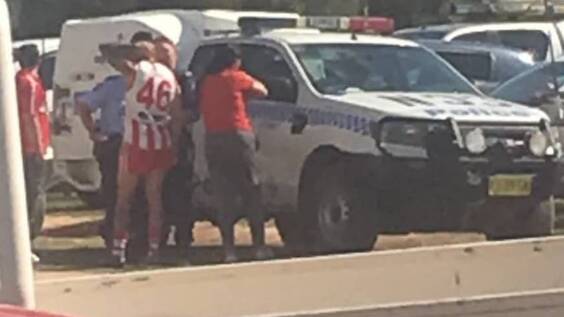 Henty footballer Jarrah Maksymow speaks with police on the day he did a runner from a Hume league semi-final at Walbundrie.