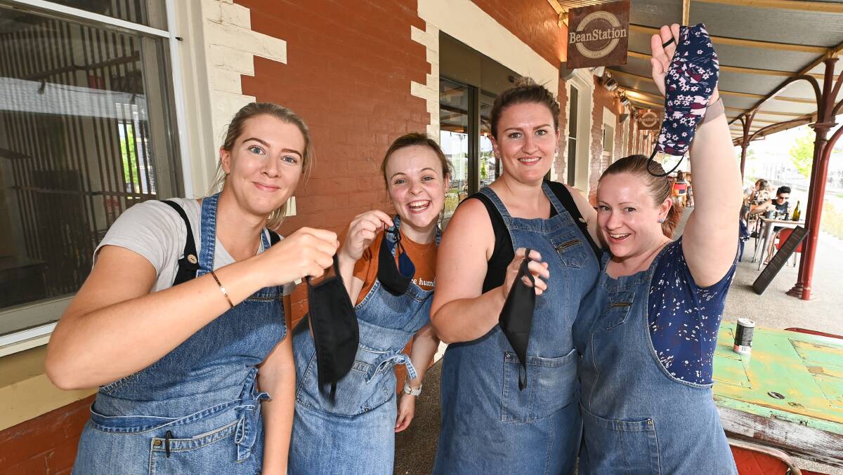 BeanStation Cafe employees Jess Ryan, Laura Chase, Sarah Benstead and Cassandra Negri celebrate mask rules easing. Picture: MARK JESSER