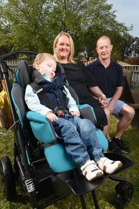 RED TAPE WRANGLE: Parents Brad and Kate Smith with four-year-old Charlie who suffers daily seizures, but can't access proper treatment. Picture: MARK JESSER