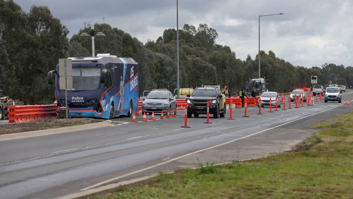TARGETED APPROACH: Victoria Police monitoring the NSW-Victoria border set up on the Bandiana Link on Monday. Premier Daniel Andrews flagged tougher controls could be coming. Picture: TARA TREWHELLA