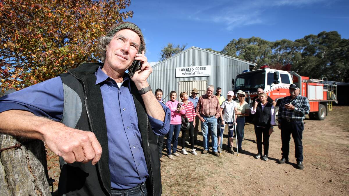 DIAL FOR CASH: Lankeys Creek residents including Steve Thompson, front, are hoping for funding to fix mobile coverage. Picture: JAMES WILTSHIRE
