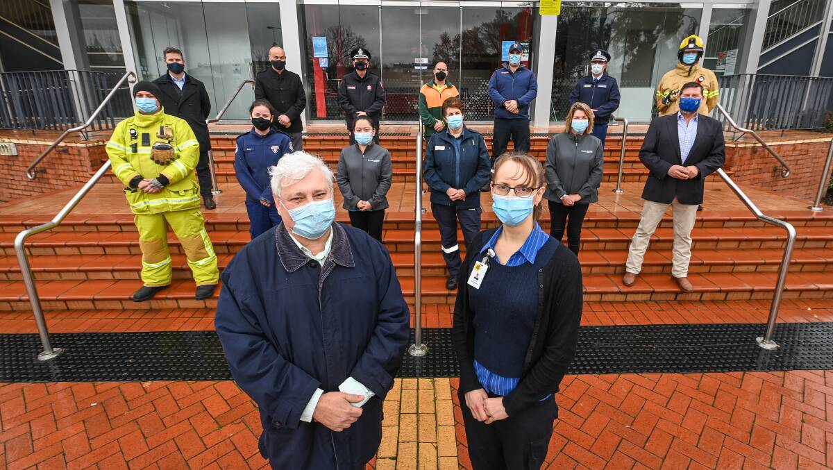 SHOUT OUT: AWH chief executive officer Michael Kalimnios and COVID vaccination program manager Jenny Keogh with politicians and emergency service personnel urging people to get jab. Picture: MARK JESSER