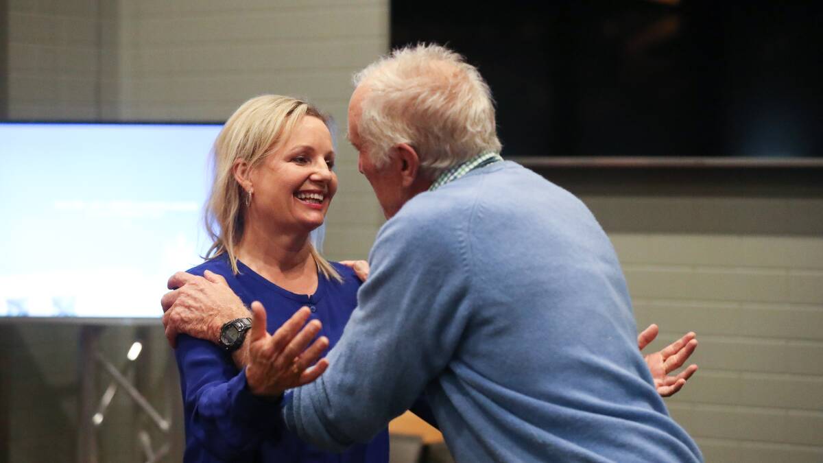 SWEET VICTORY: Liberal MP Sussan Ley is congratulated by her long-time campaign manager Angus Macneil on Saturday night. Picture: MARK JESSER