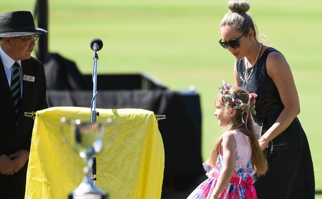 ULTIMATE HONOUR: Karl Jacka's wife Cristy and daughter Lucy pay their last respects at his funeral at Lavington Oval on Friday. Picture: MARK JESSER
