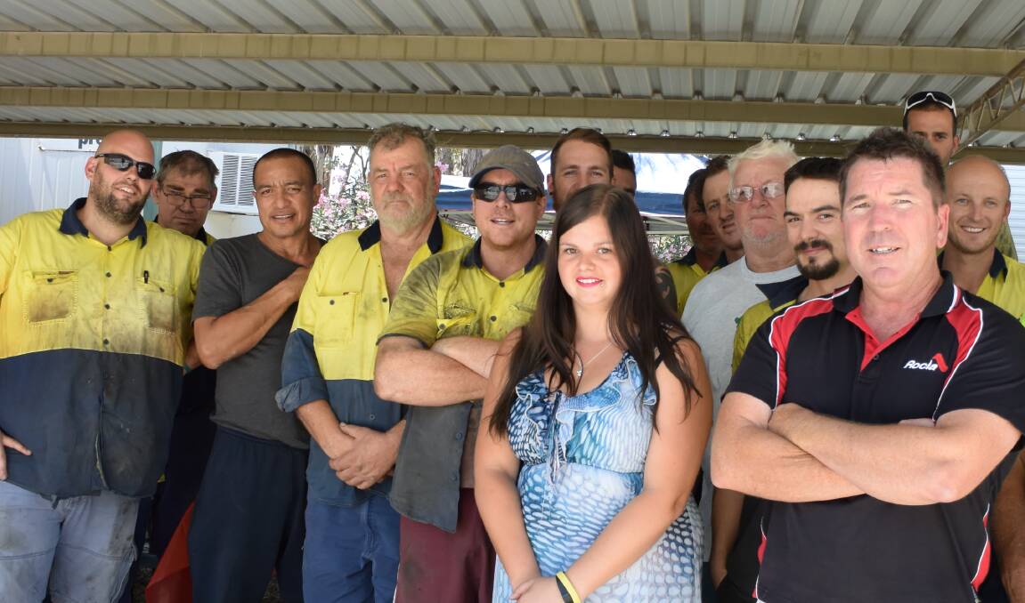 HELPING OUT: Jodi Kelly stands with Simon Rigby and some of James Shaw's workmates, who gave her a gift at a luncheon on Friday.