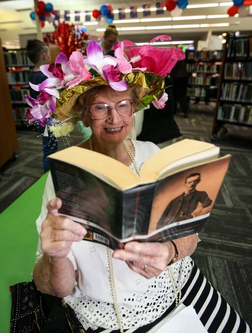 STORIES THROUGH TIME: Ruth Green dressed up and picked out one of her favourite books during the 100-year library celebration on Friday. Picture: JAMES WILTSHIRE