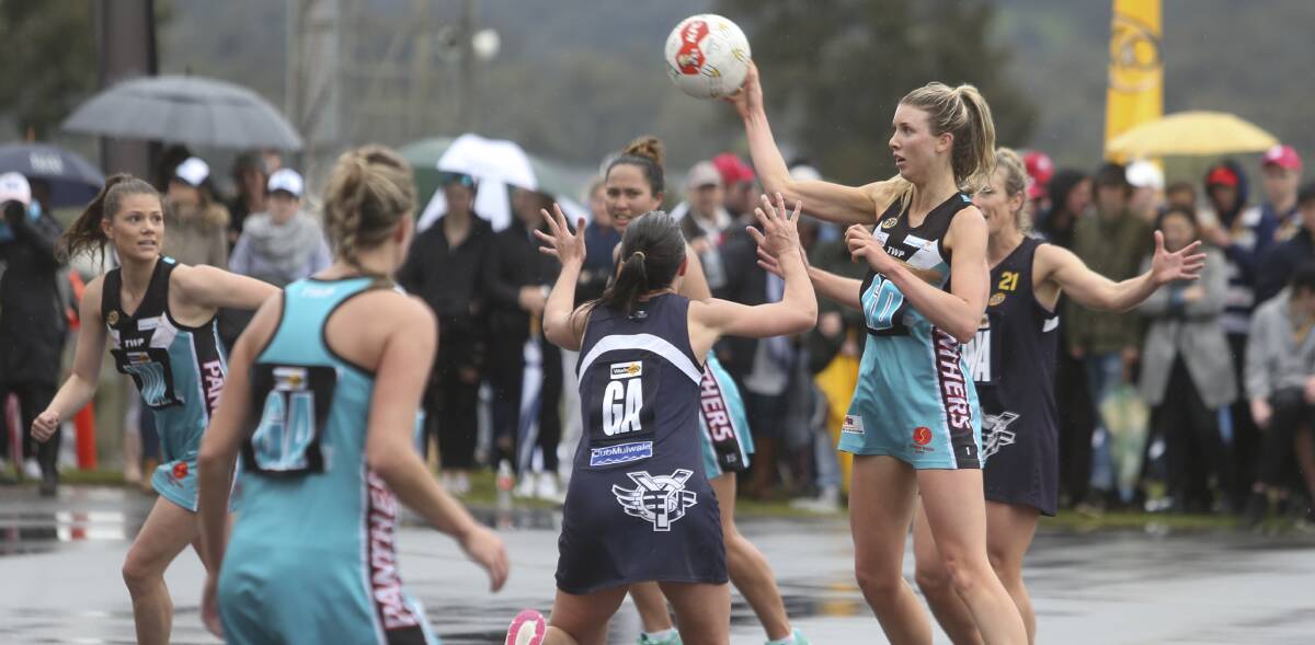PHYSICAL CLASH: Sarah Meredith off-loads the ball to a teammate during the A grade grand final as Yarrawonga's Laura Davis goes in to defend.